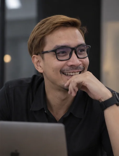 AI-styled portrait of Prapak beside a laptop