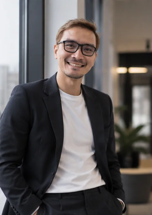 AI-styled portrait of Prapak in a blazer beside a window